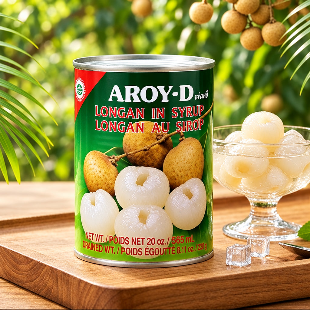 Can of Aroy-D longan in syrup on a wooden tray with longan fruits in the background