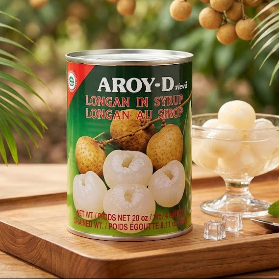 Can of Aroy-D longan in syrup on a wooden tray with longan fruits in the background